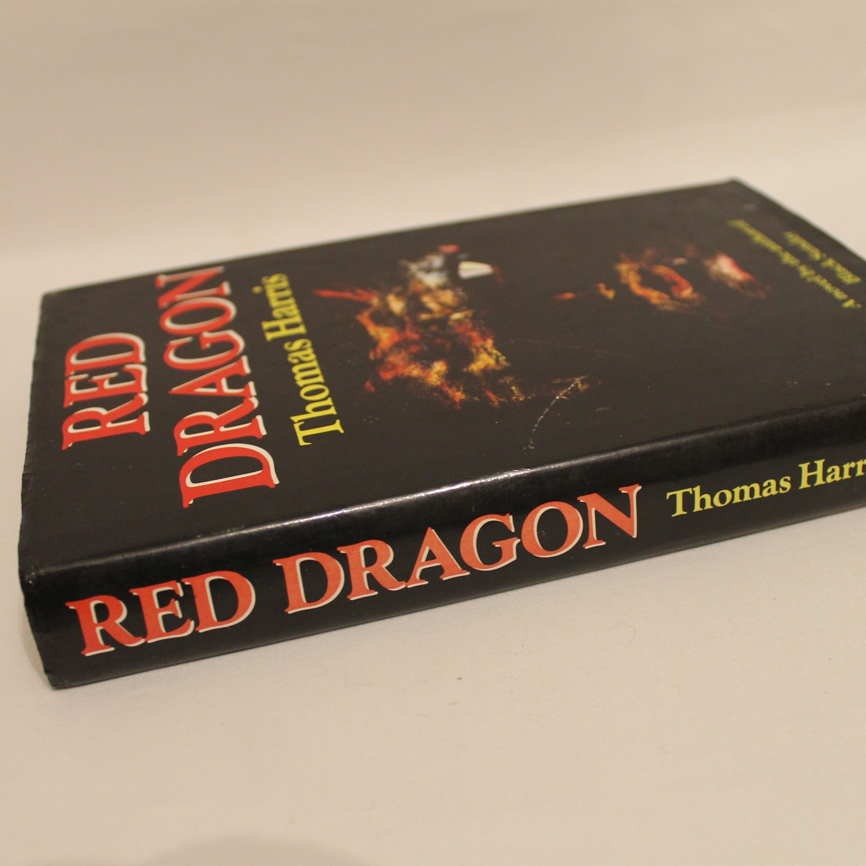 Book titled 'Red Dragon' by Thomas Harris on a beige background