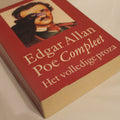 Book titled 'Edgar Allan Poe Compleet' with a portrait on the cover against a beige background