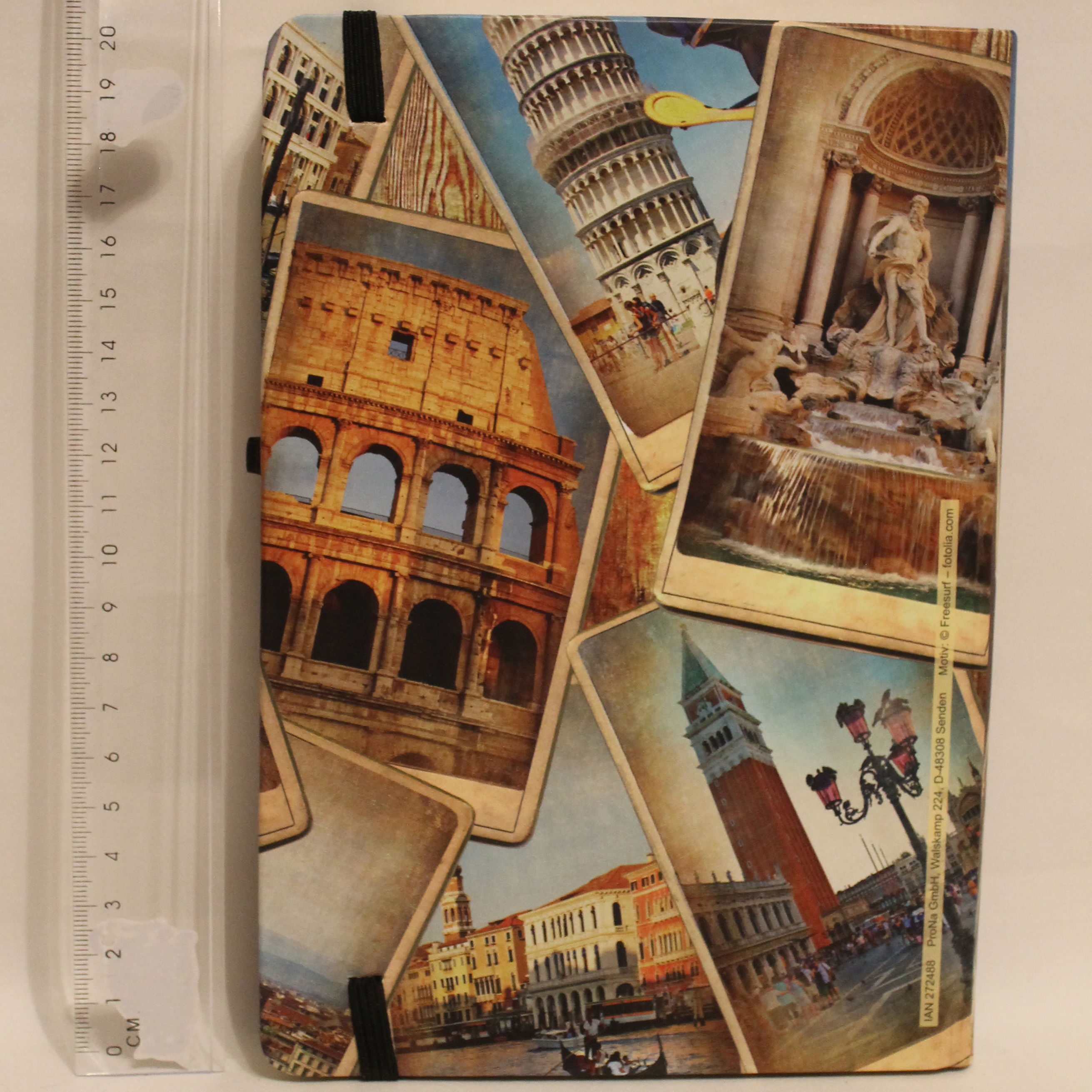 Notebook with Italian landmarks design next to a ruler and pencil