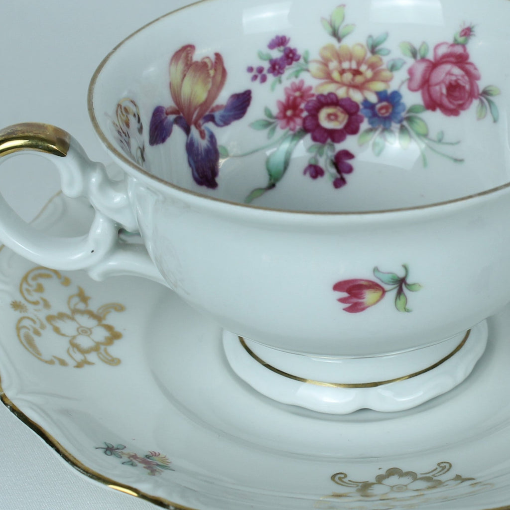 Teacup and saucer with floral design on a white background