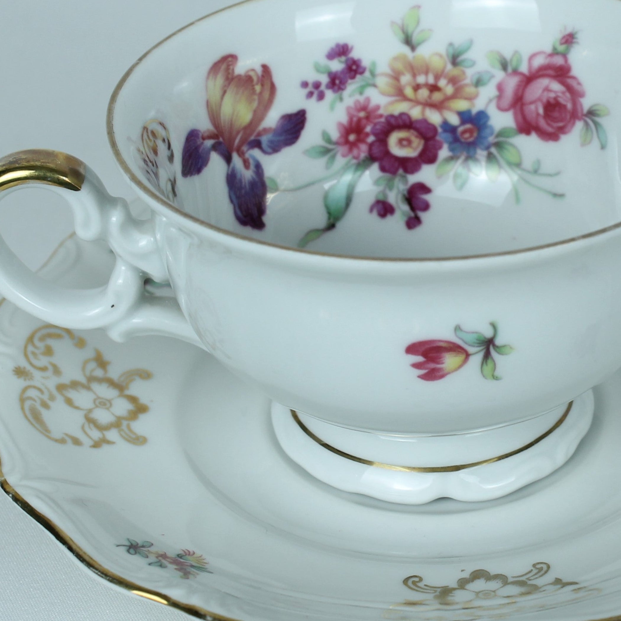 Teacup and saucer with floral design on a white background