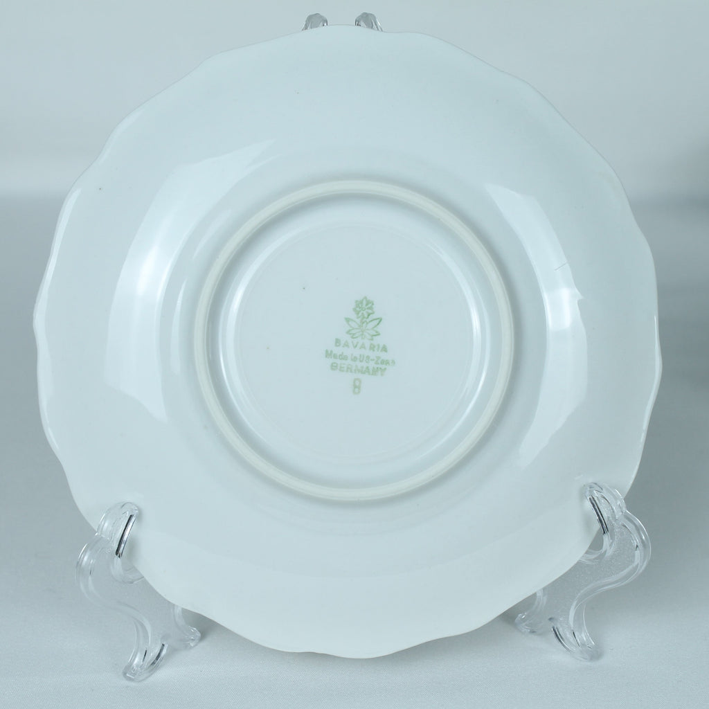 White ceramic plate with a logo on a white background