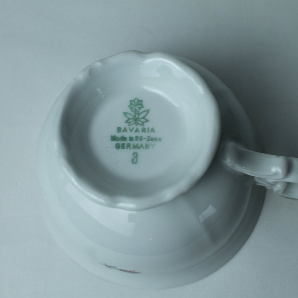 White ceramic cup with handle on a gray background