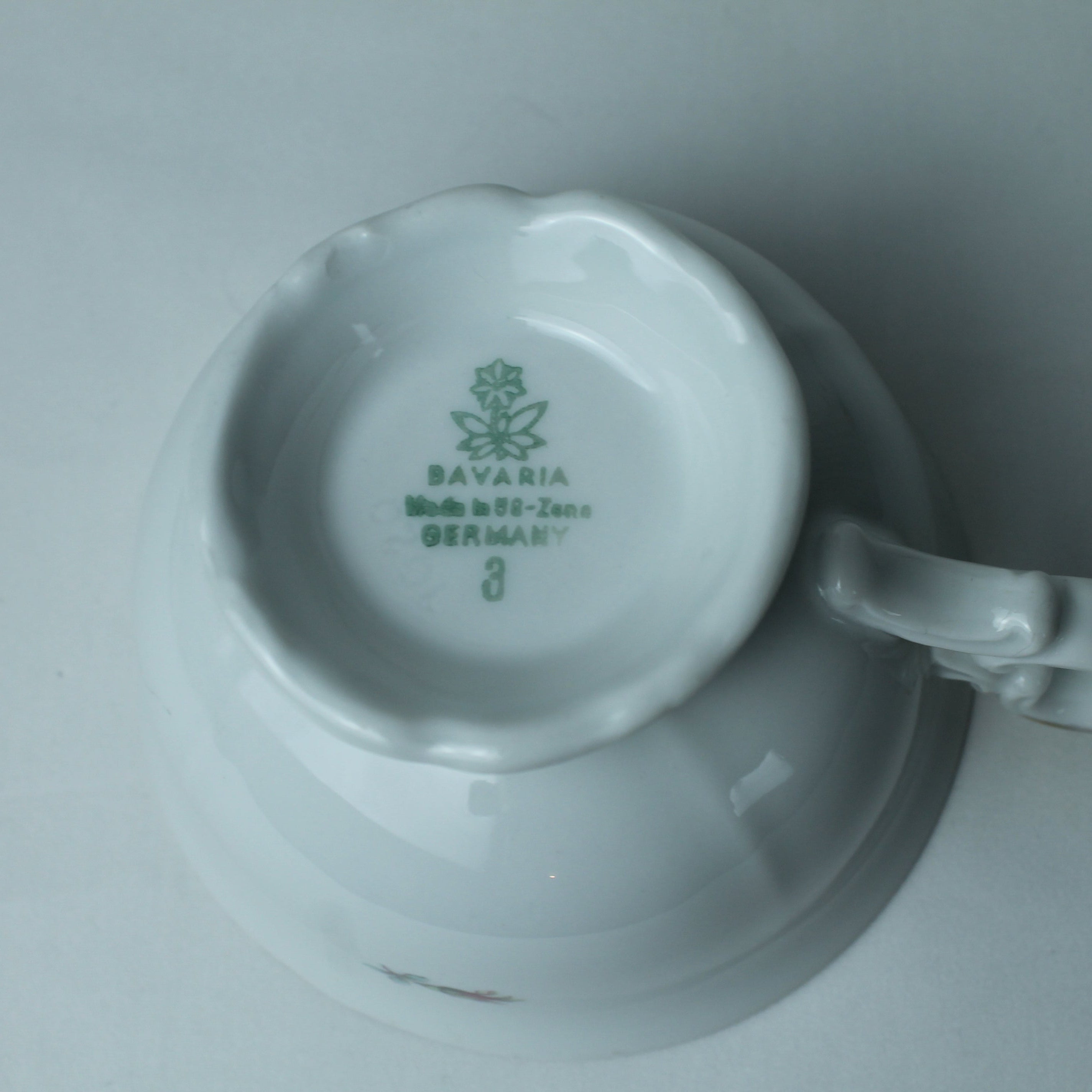 White ceramic cup with handle on a gray background