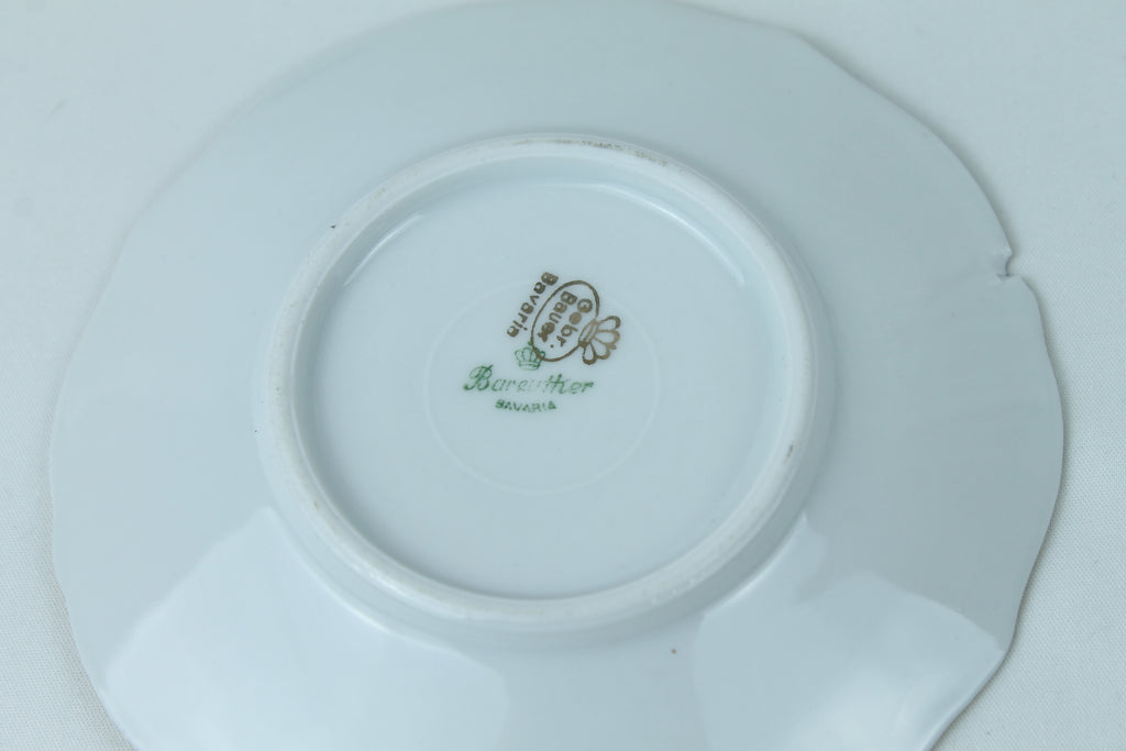 White ceramic plate with a visible brand logo on a white background