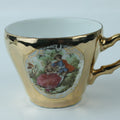 Decorative teacup with gold rim and handle on a white background