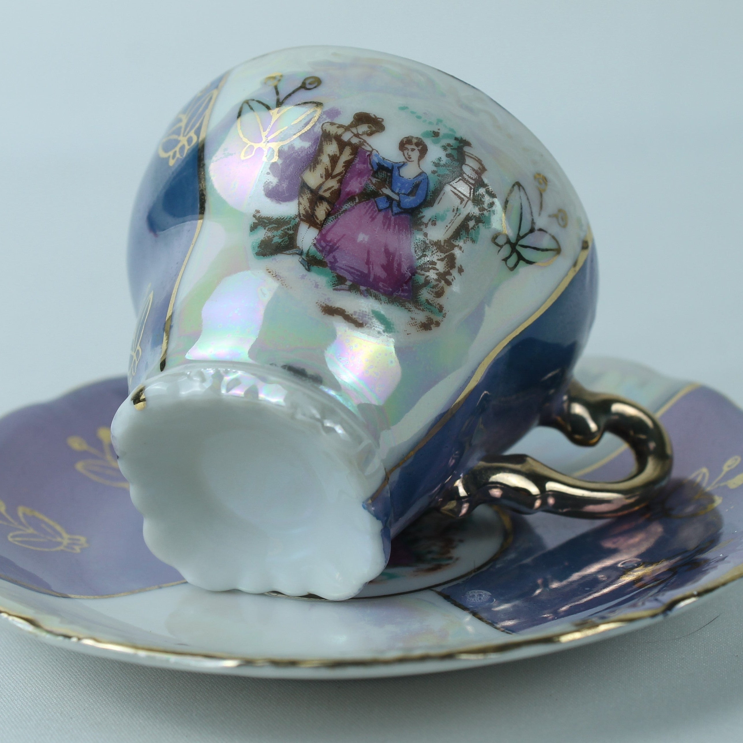 Decorative teacup and saucer with artistic design on a light blue background