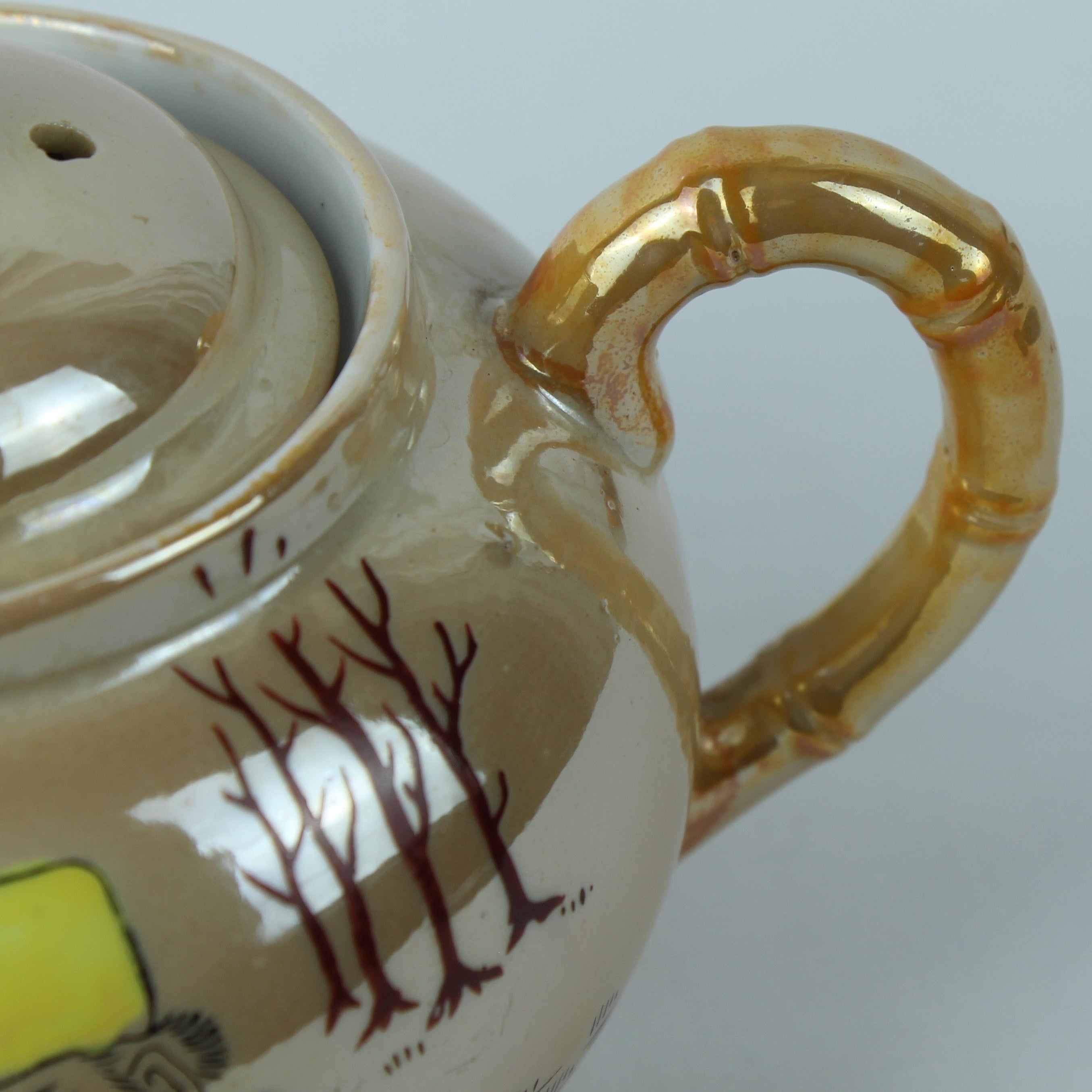 Ceramic teapot with a lid and handle on a white background