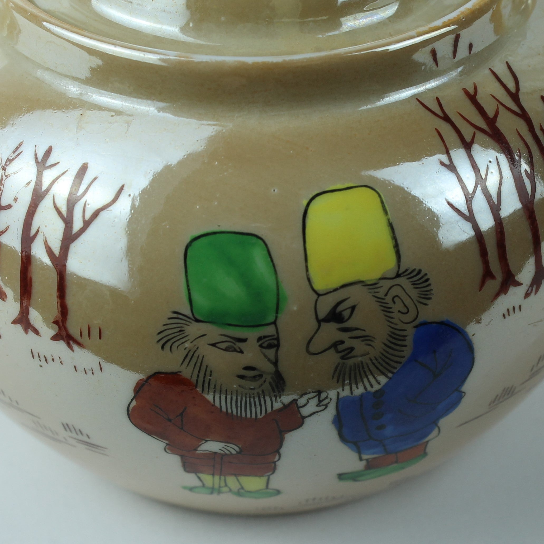 Ceramic teapot with colorful animal illustrations on a white background