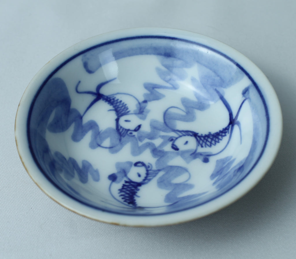 Petit bol bleu et blanc avec motif de poisson (±8 cm) – extérieur vitré marron