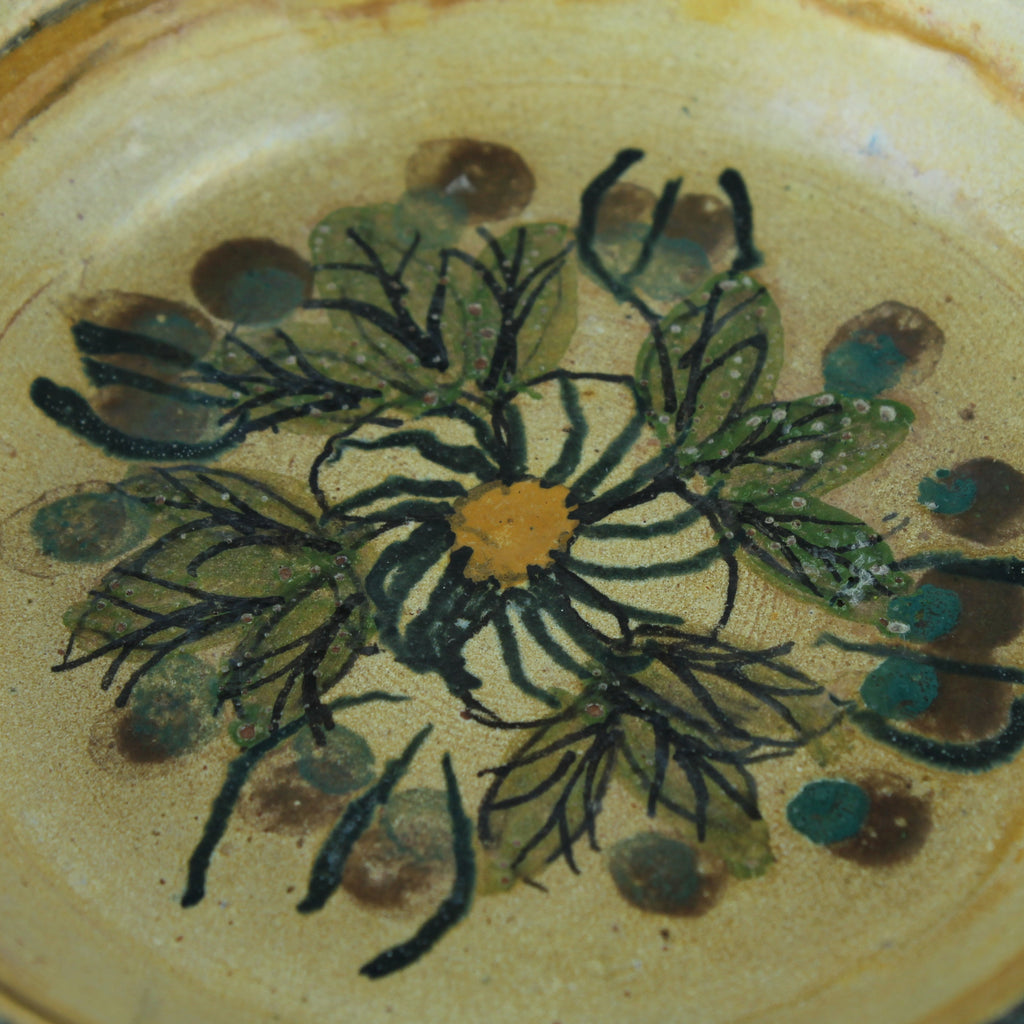 Ceramic plate with floral design on a beige background