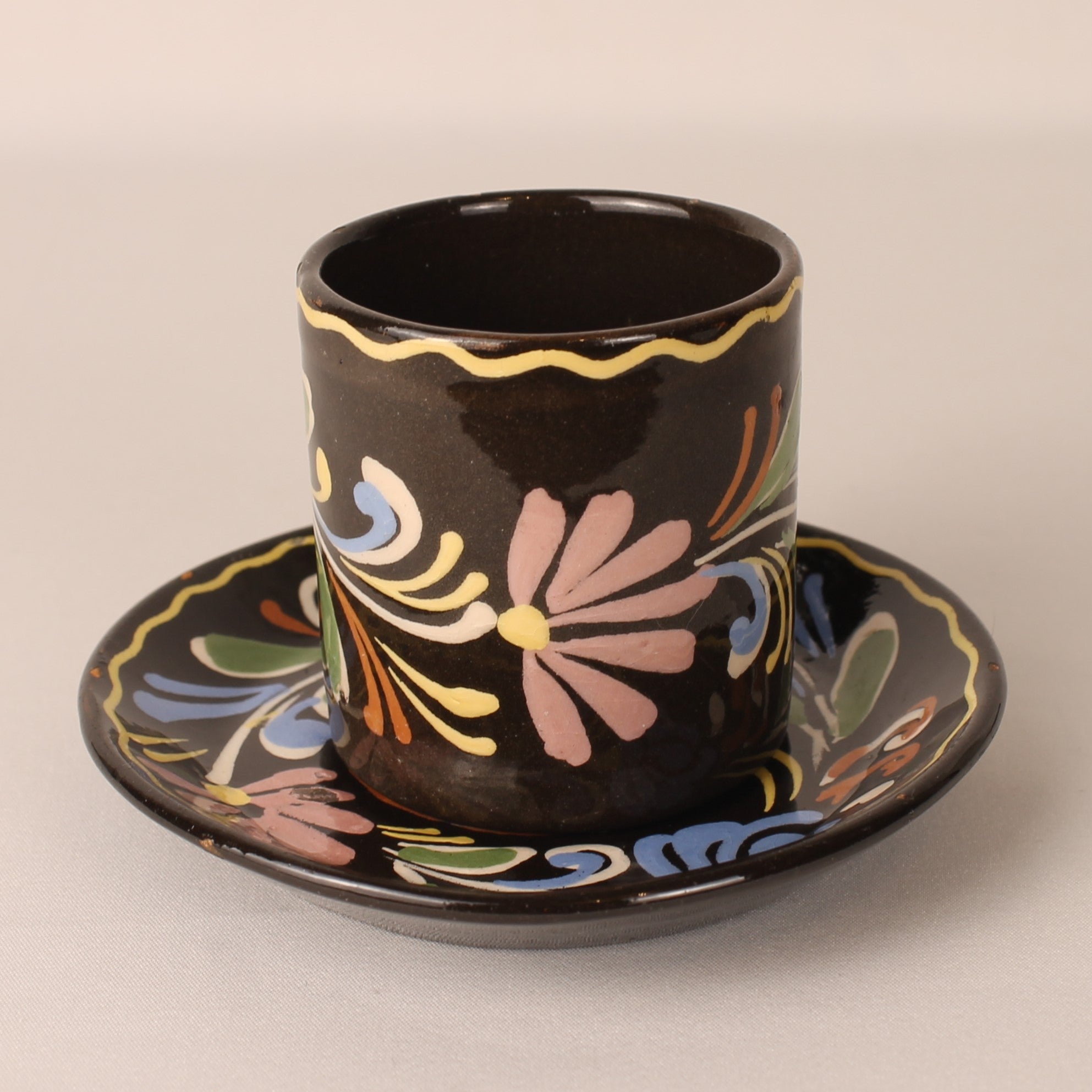 Vintage hand-painted espresso cup and saucer – brown ceramic with colorful floral motif