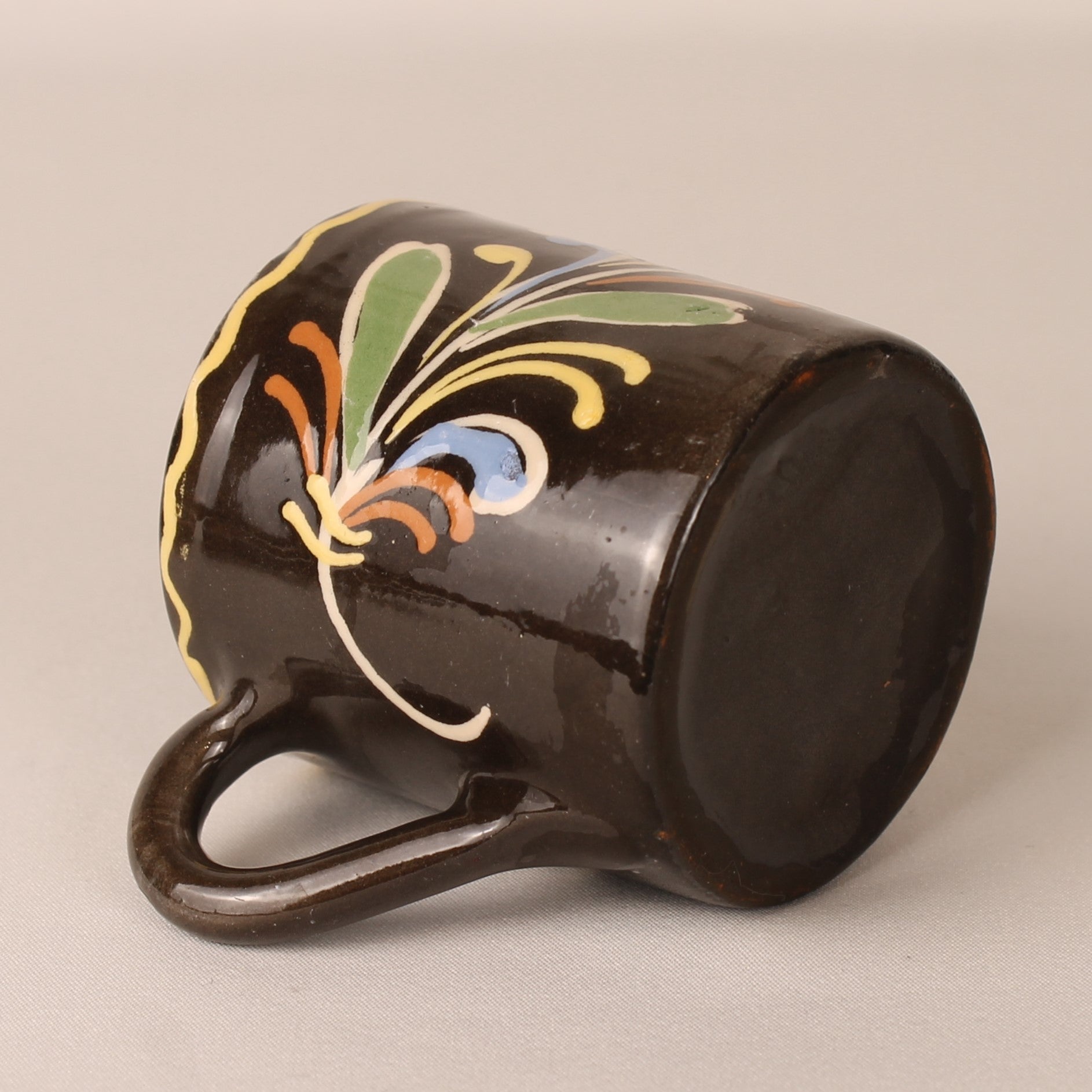 Vintage hand-painted espresso cup and saucer – brown ceramic with colorful floral motif