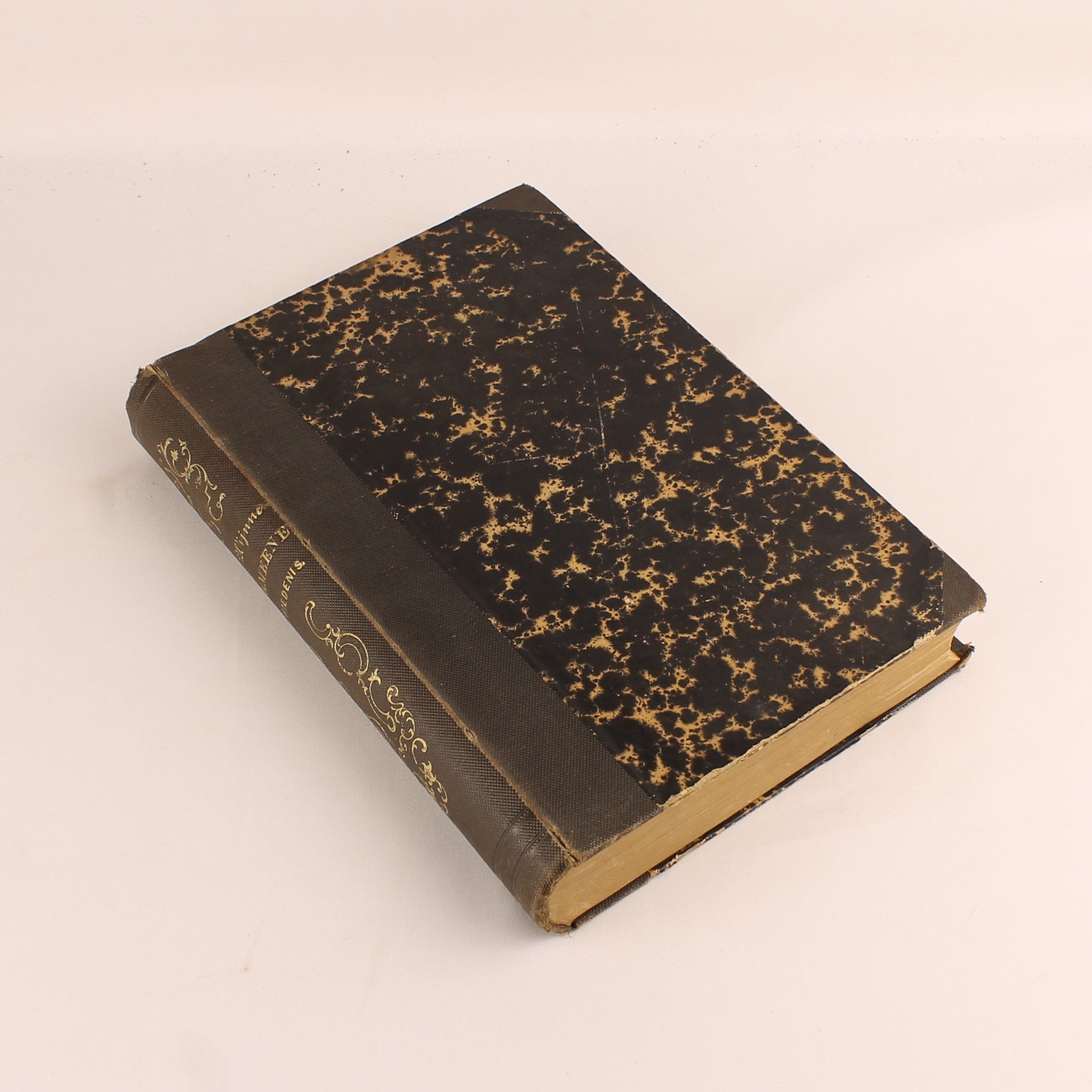 Vintage book with worn leather binding on a beige background