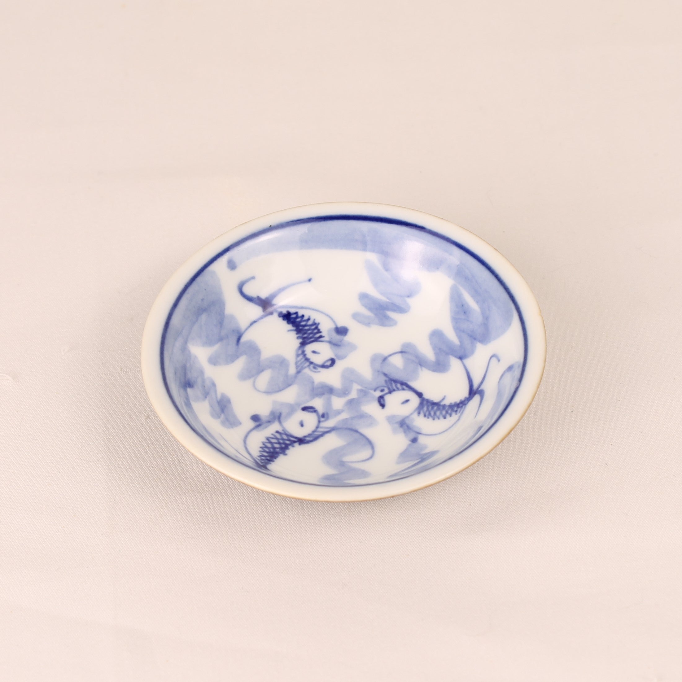 Klein blauw-wit schaaltje met vismotief (±8 cm) – bruin geglazuurd buitenwerk