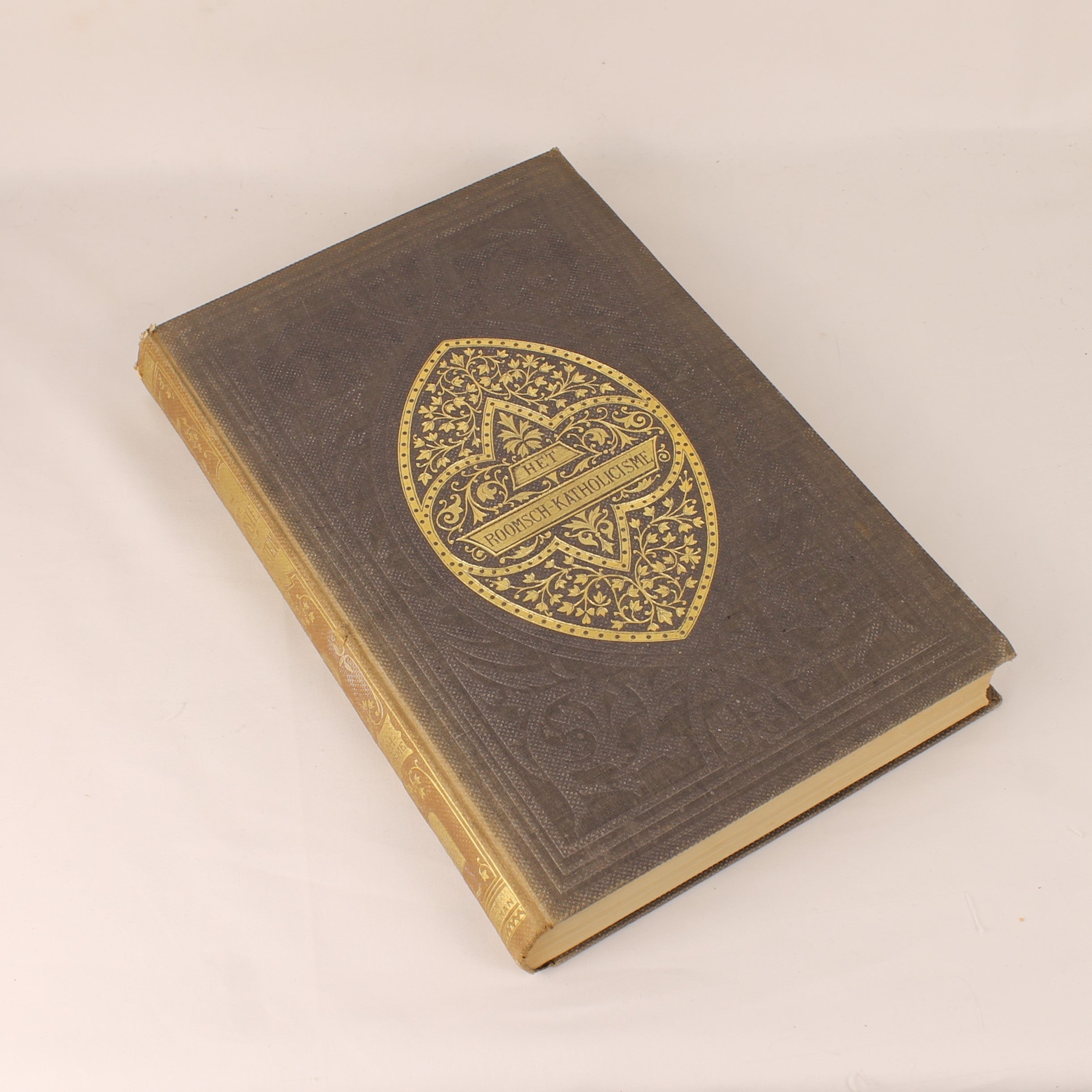 Vintage book with decorative emblem on a beige background