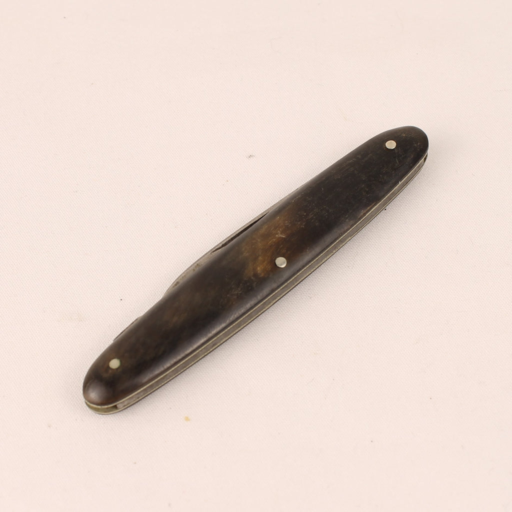Wooden pocket knife on a beige background