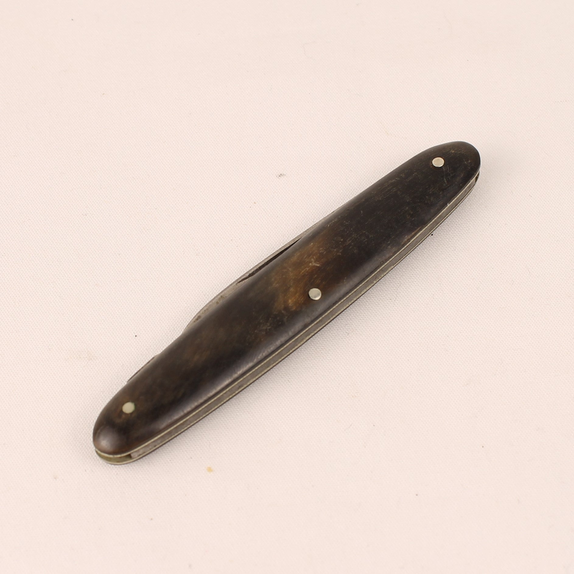 Wooden pocket knife on a beige background