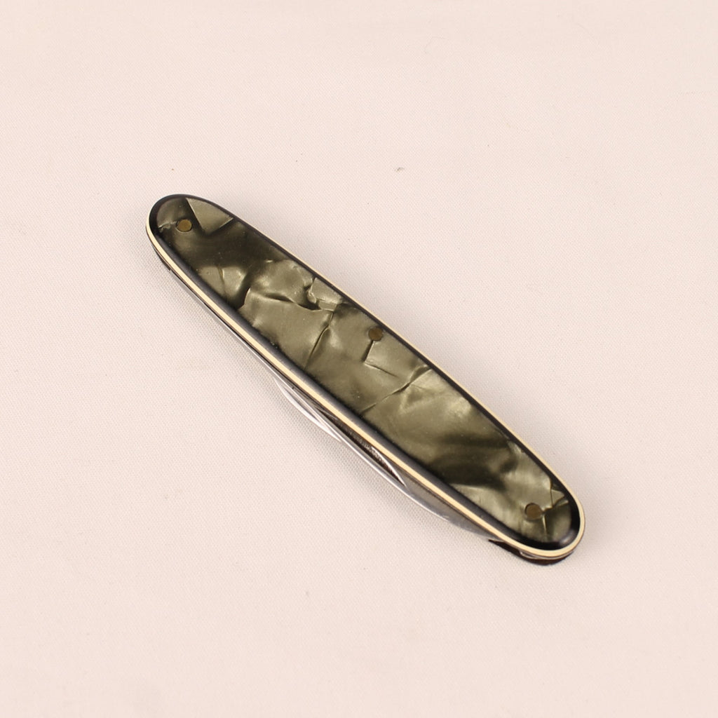 Metallic object with a textured surface on a beige background