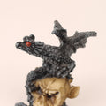 Dragon figurine with red eyes on a beige background