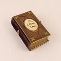 Decorative book with gold embossed cover on a beige background