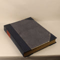 Vintage book with dark leather binding on a light background
