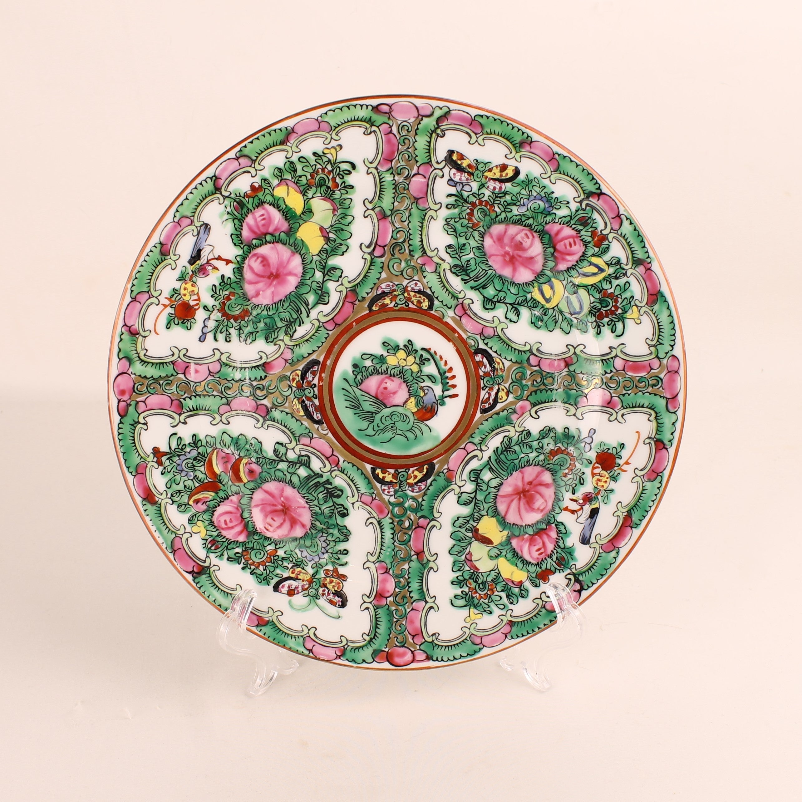 Decorative ceramic plate with floral and bird patterns on a beige background