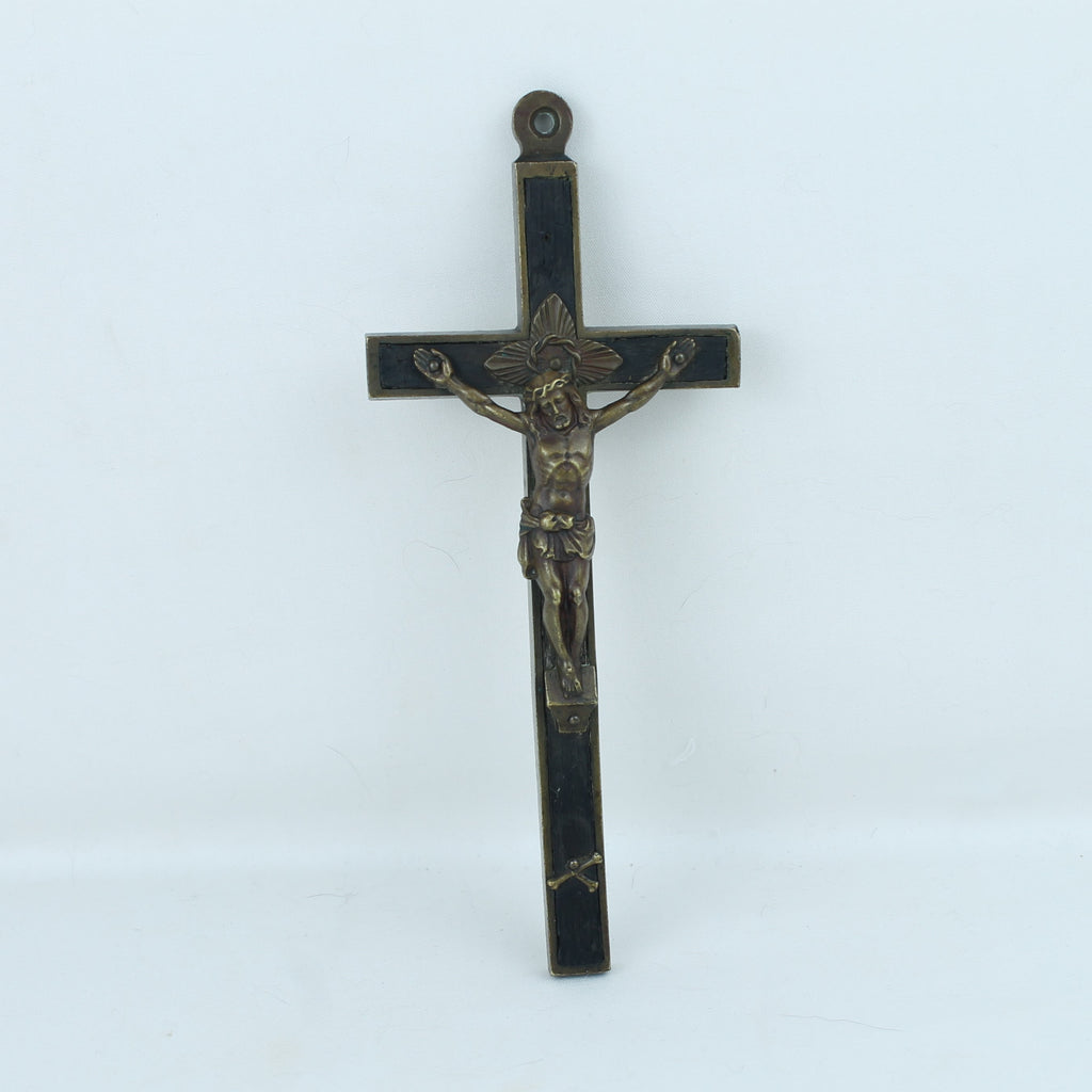 Decorative crucifix with black and gold details on a white background