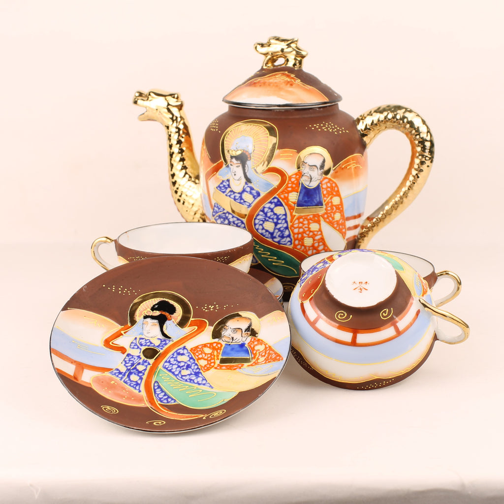 Decorative teapot set with artistic designs on a beige background