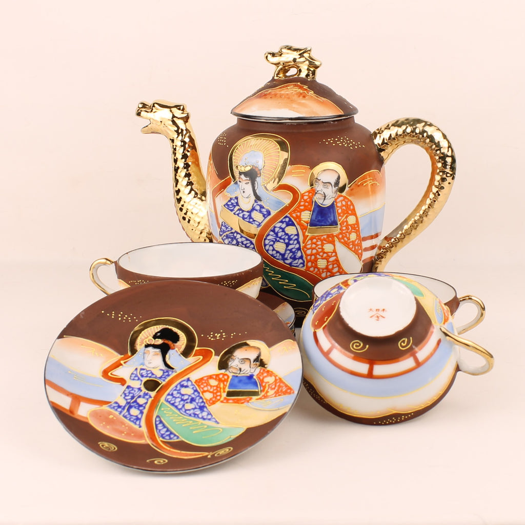 Ceramic teapot set with artistic designs on a beige background