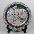 Decorative ceramic plate with traditional design on a stand against a white background