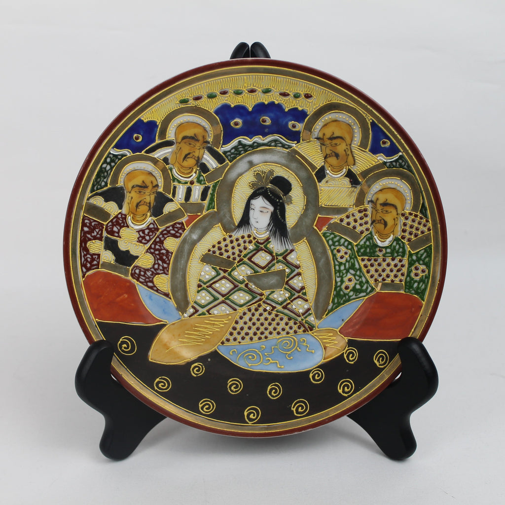 Decorative plate with artistic design on a stand against a white background