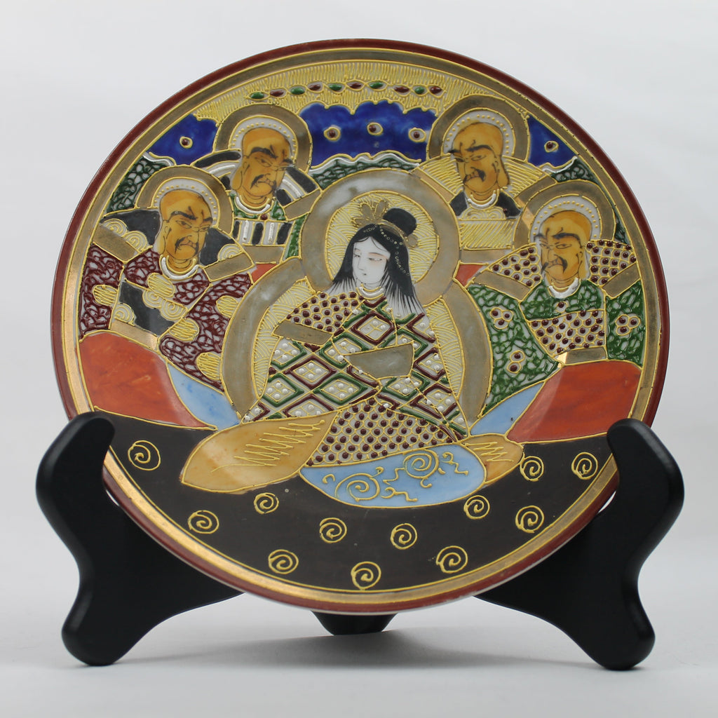 Decorative plate with artistic design on a stand against a white background
