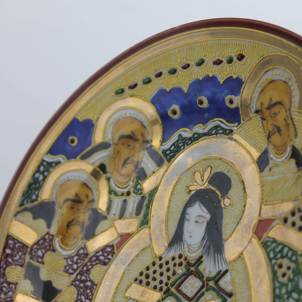 Decorative plate with artistic depiction of figures on a plain background