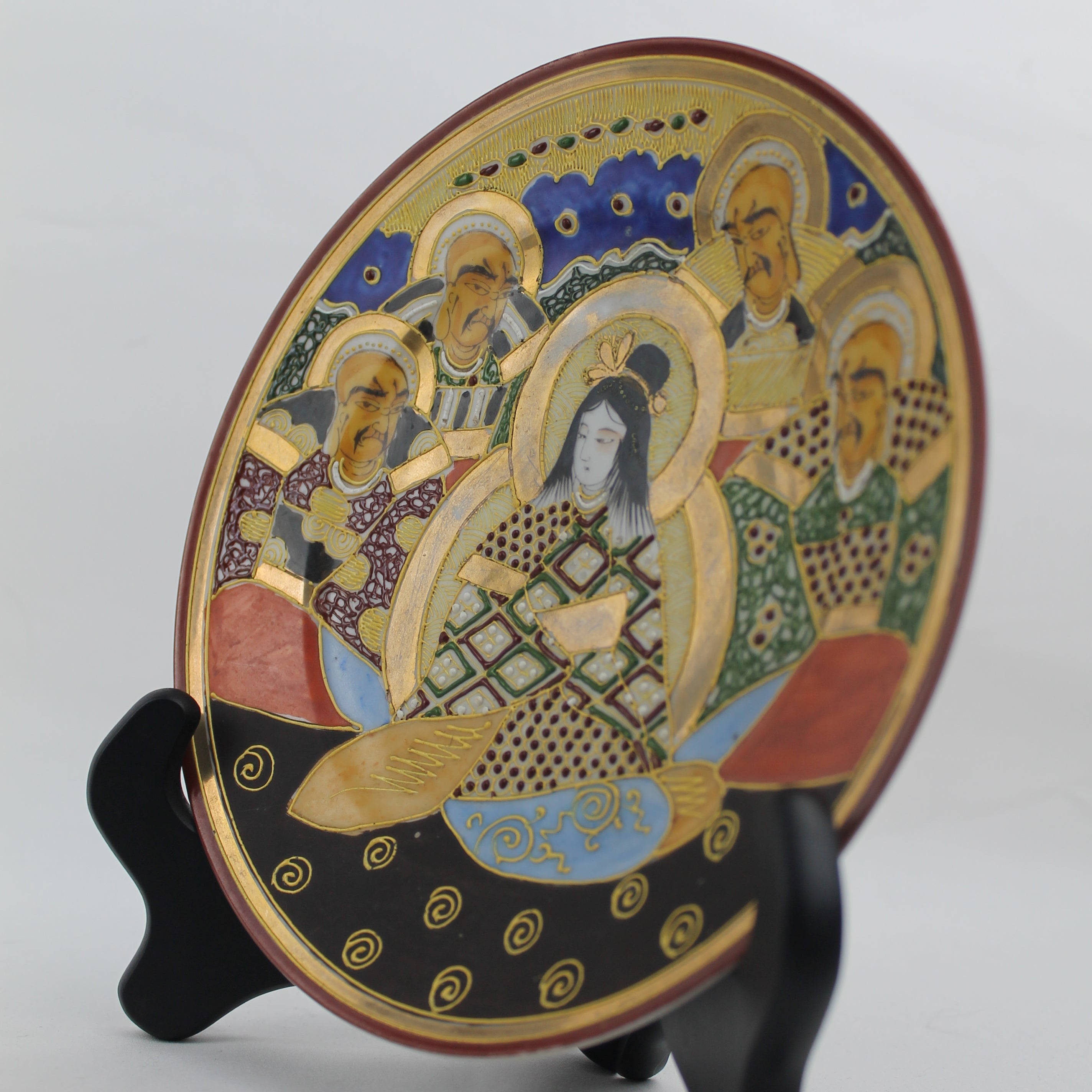 Decorative plate with artistic design on a stand against a light background