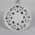 White plate with blue floral patterns on a gray background