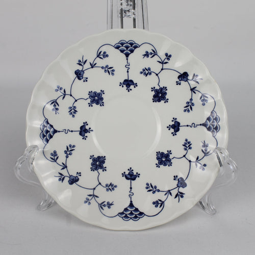 White plate with blue floral patterns on a gray background