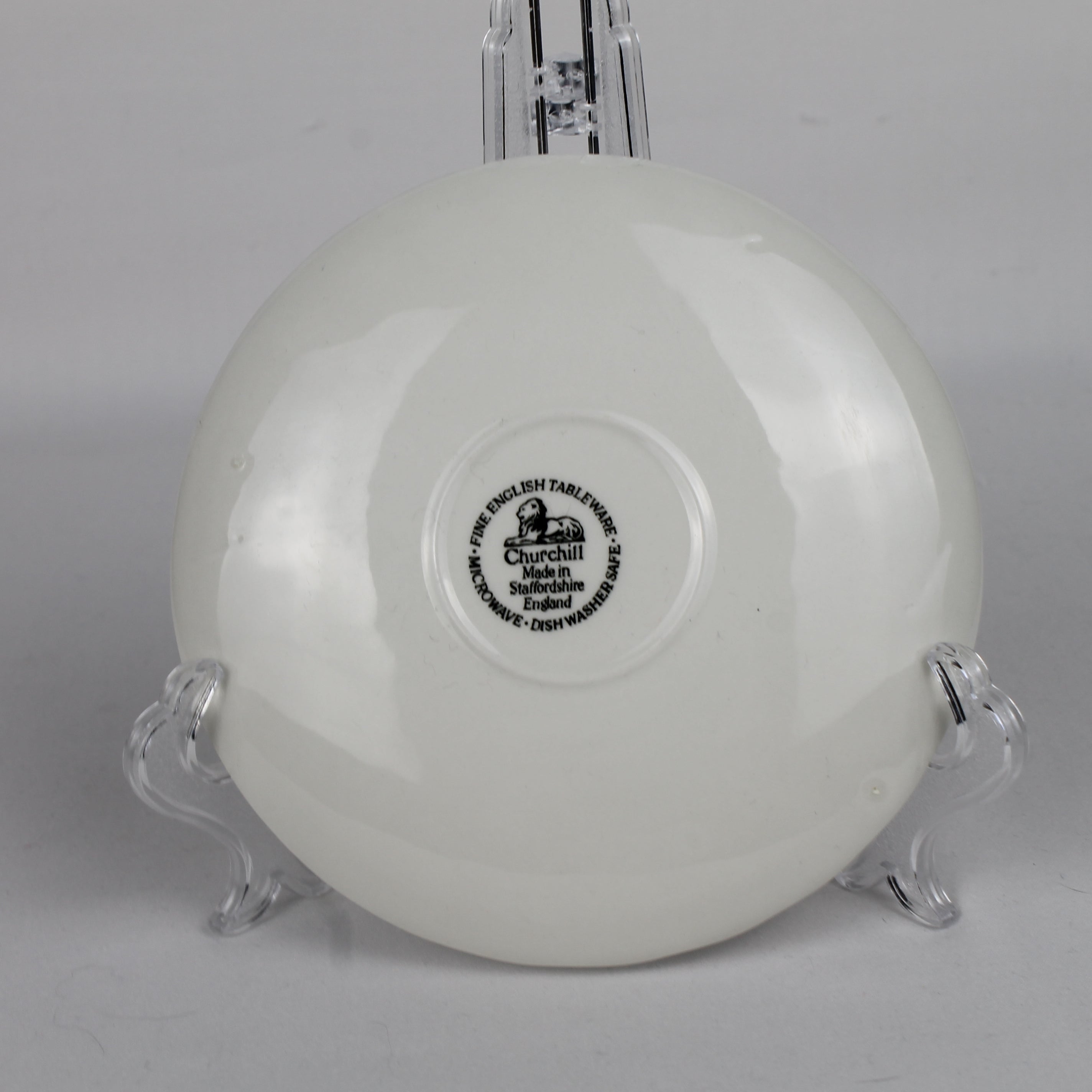 White ceramic bowl with a visible brand logo on a gray background