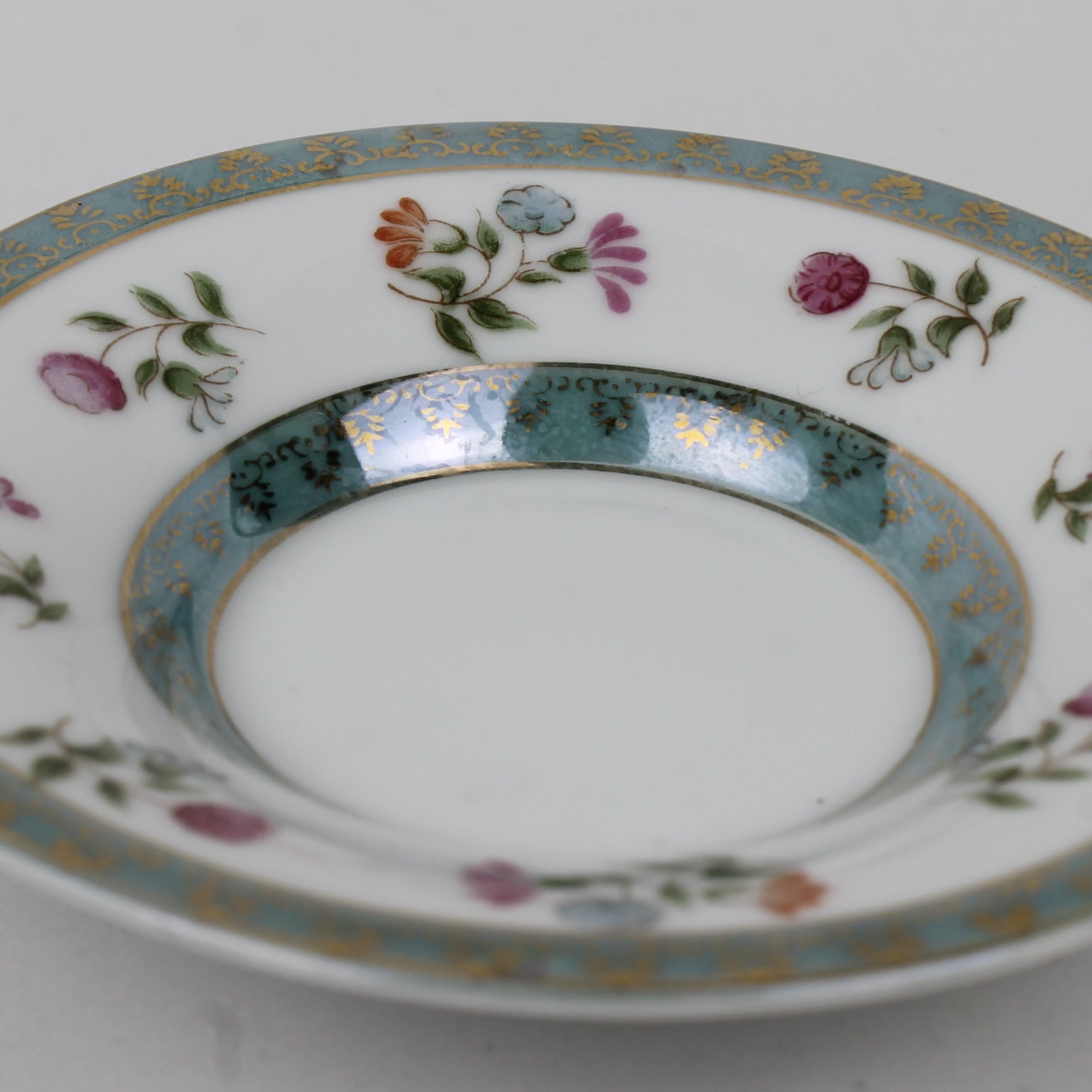 Decorative ceramic plate with floral patterns on a plain background