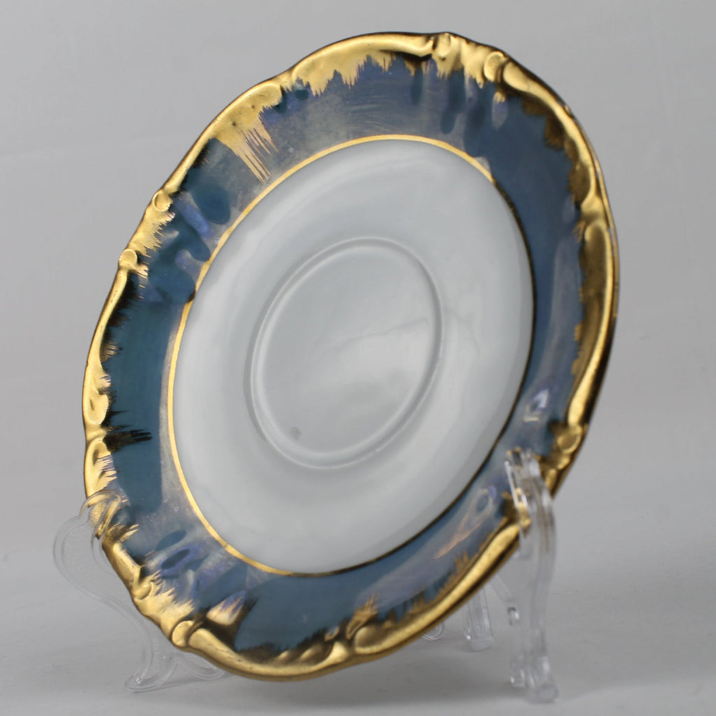 Decorative plate with gold rim and blue interior on a gray background