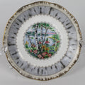 Decorative plate with floral and landscape design on a white background