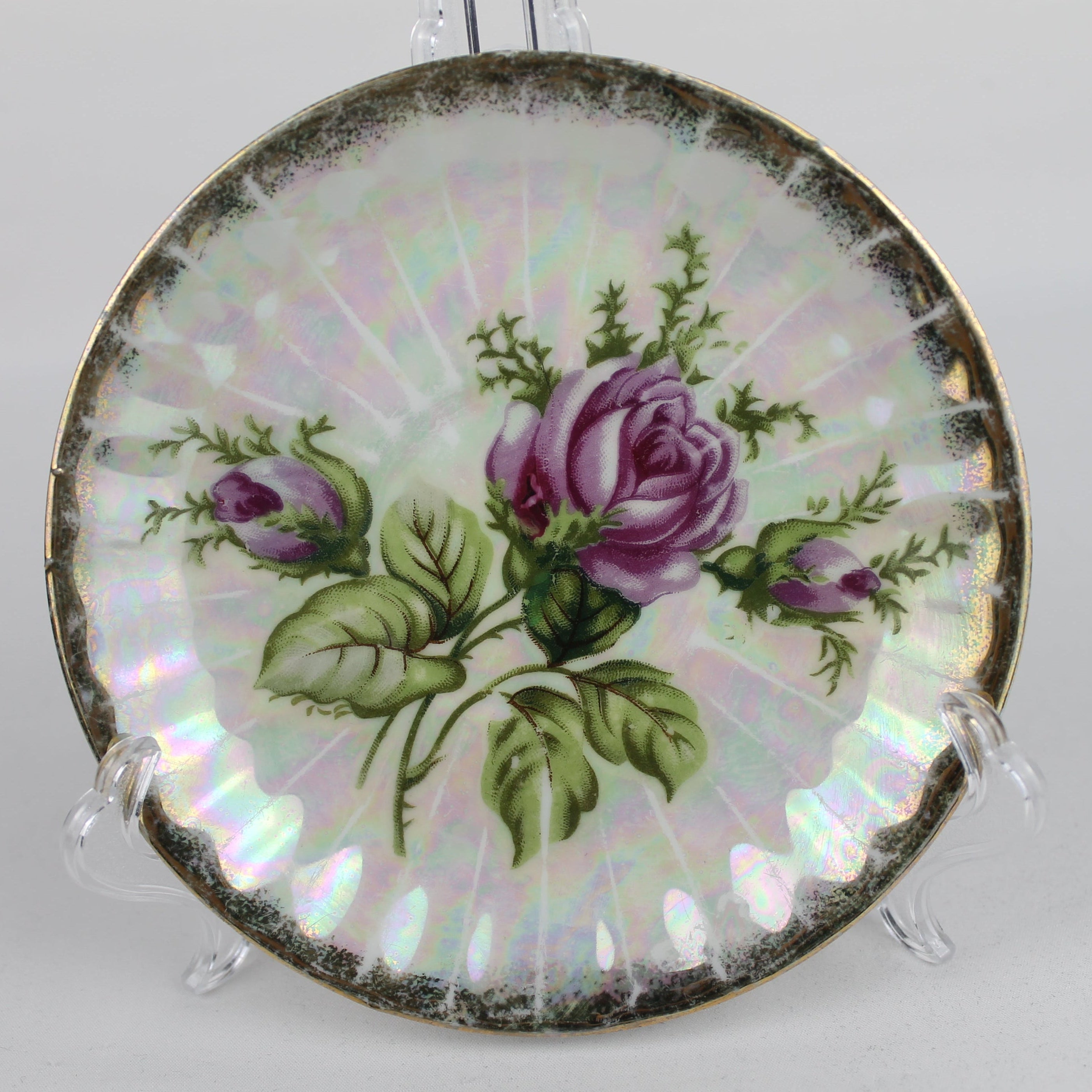 Decorative plate with a floral design featuring purple roses on a white background